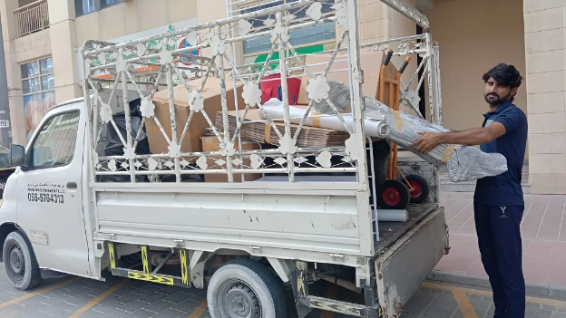 Founder of Movers In Dubai managing a residential furniture relocation with his own moving team and vehicle