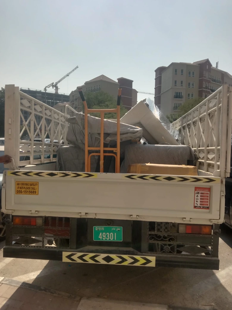 Movers in Dubai team loading securely packed household furniture onto a relocation truck for safe transportation