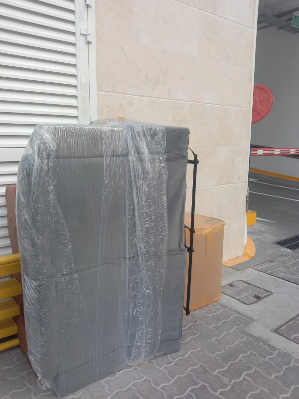 Securely wrapped furniture prepared for transport during a residential relocation