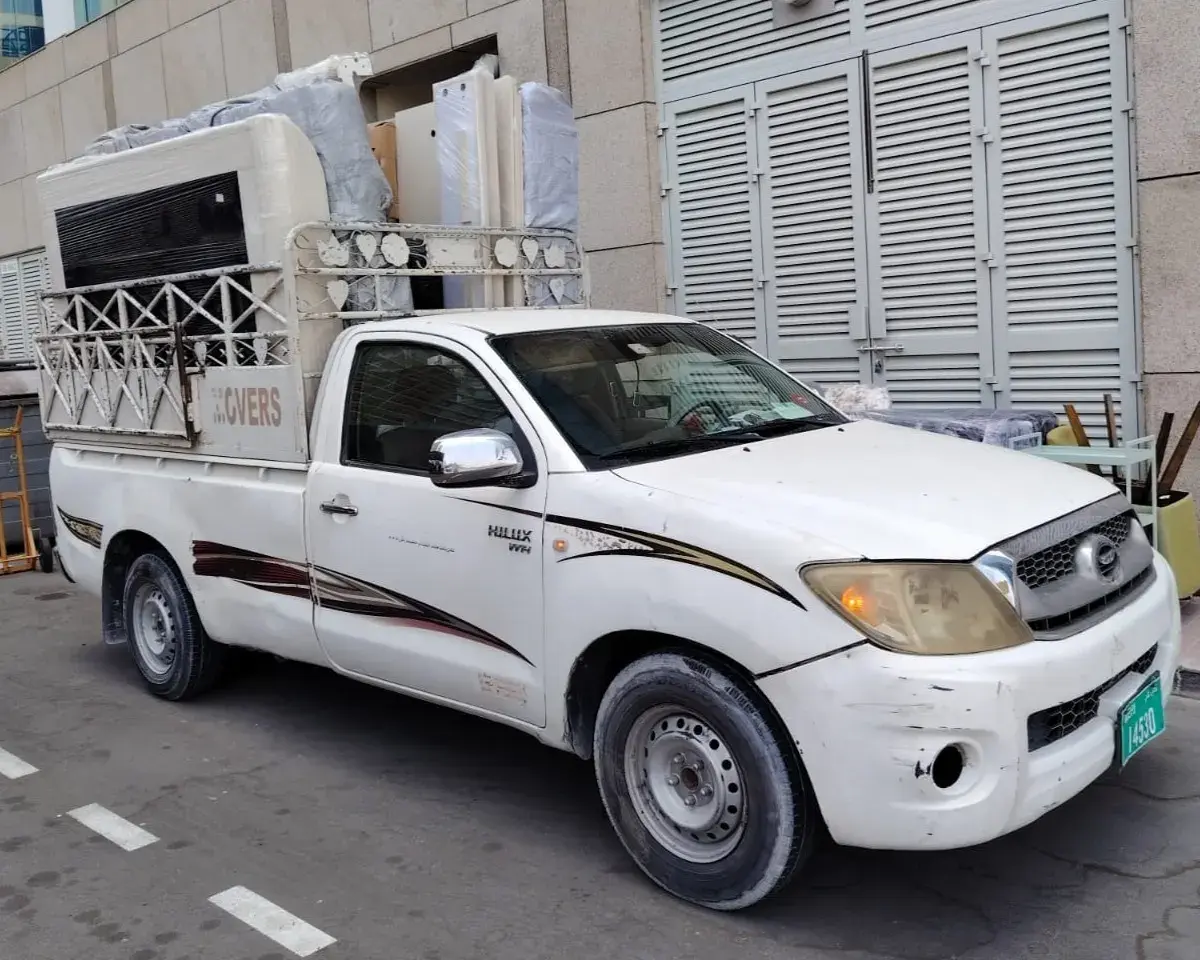 Professional moving pickup truck loaded with securely packed household furniture for residential relocation