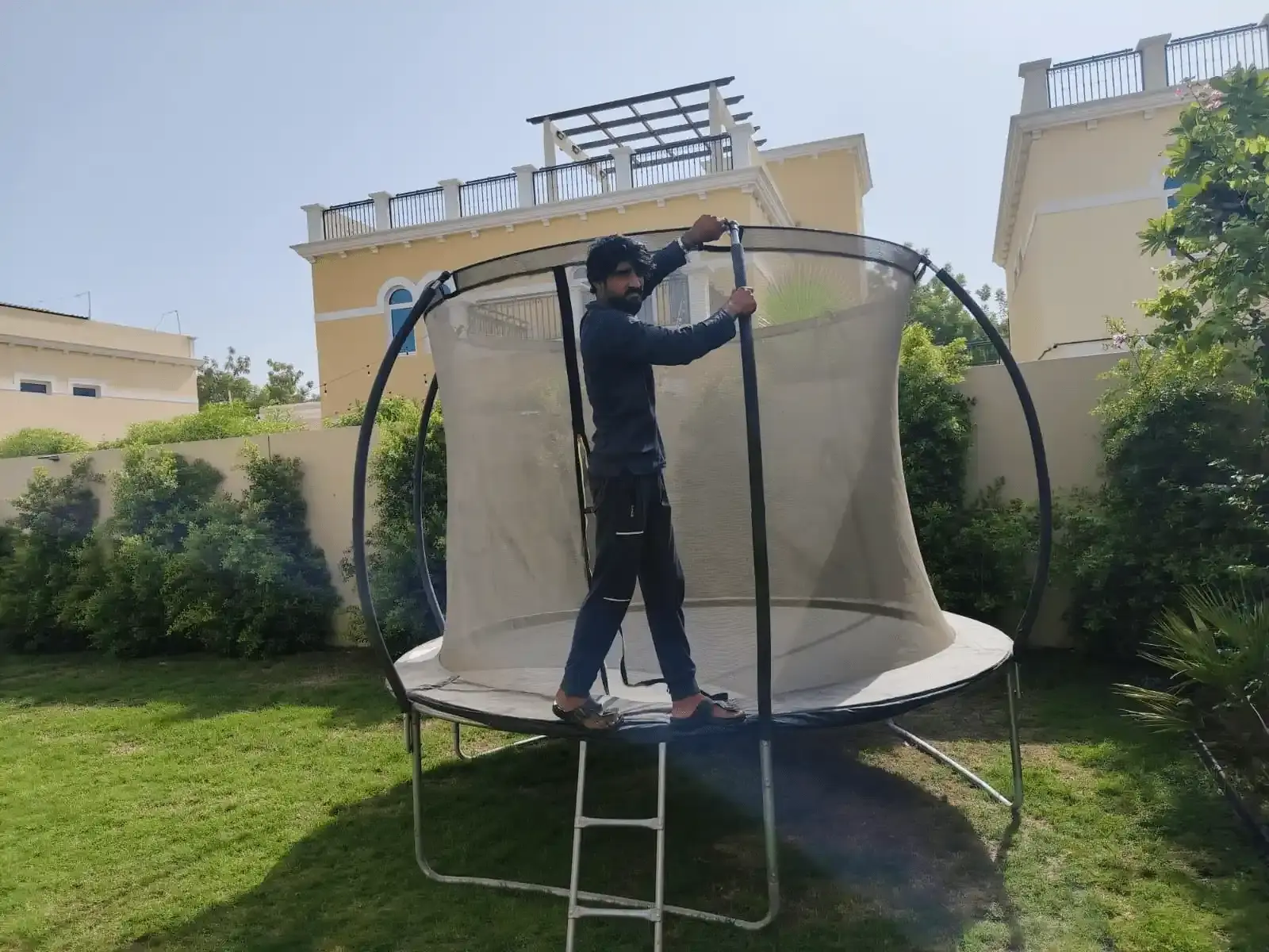 Experienced mover dismantling outdoor equipment during a residential move in Dubai Silicon Oasis