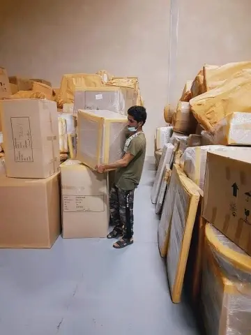 Professional Movers in Dubai Marina handling securely packed household furniture with care